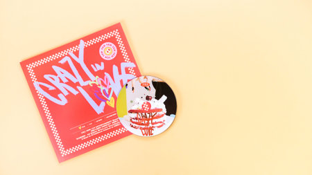 K-pop group Itzy CRAZY IN LOVE 1st Album on yellow background. Special edition music CD. South...