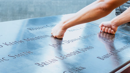 Hands on Memorial at Ground Zero Manhattan for September 11 Terrorist Attack with Engraved Names of Victims. Patriot Day - New York NY USA 2023-07-30.のeditorial素材