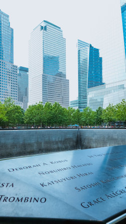 People at Ground Zero Memorial Manhattan for September 11 Terrorist Attack with Engraved Names of Victims. Patriot Day - New York NY USA 2023-07-30.のeditorial素材