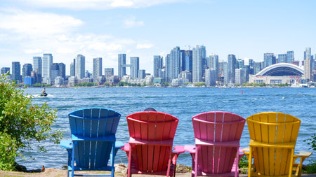 Panoramic view of Toronto skyline, Lake Ontario with colorful chairs on a sunny day, Toronto, Ontario, Canada.のeditorial素材