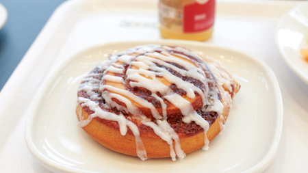 Delicious freshly baked cinnamon rolls on white plate. Breakfast at restaurant