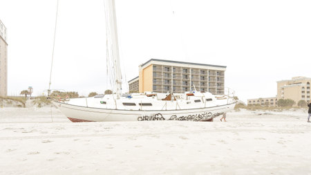 Dramatic Scene of a Yacht Stranded on a Sandy Beach After a Destructive Hurricane Storm - Jacksonville, Florida USA 03.15.2024のeditorial素材