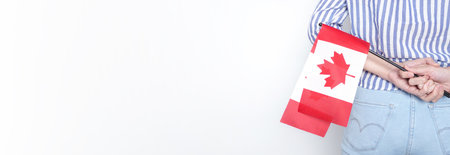 Miniature Canadian flag stands out of the back pocket of blue jeans.の写真素材