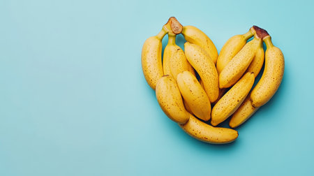 Heart of Bananas on Sky Blue Background Valentine s Day Greeting, Fresh Fruits on Solid Color.の素材