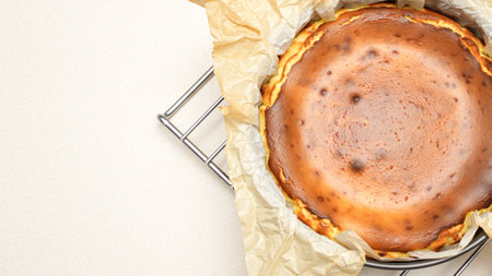 Delicious Cheesecake With caramel Crust And Creamy Filling Baked To Perfection standing on baking rack.の写真素材