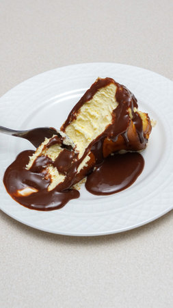 Delicious and Indulgent Cheesecake with Rich Chocolate Fudge Sauce Topping for Dessert Lovers.の写真素材