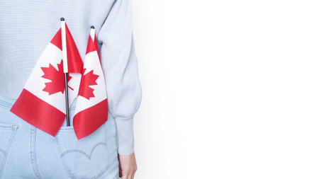 Miniature Canadian flags stands out of the back pocket of blue jeansの写真素材