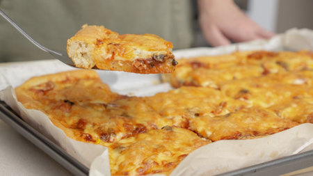 Homemade square pizza with cheese and sausage topping served on wooden table Square pizza, full cheese spread organic pizza healthy pizza.の写真素材