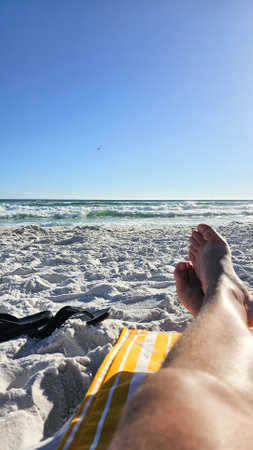 Experience a peaceful beach vacation with warm sun, soft sand, and gentle waves. This scene captures relaxation and tranquility, perfect for travel and leisure themes.の写真素材