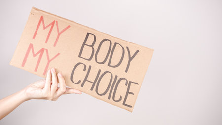 A hand holds a sign that reads My Body, My Choice , representing the pro-choice movement and the struggle for women s reproductive rights, advocating for personal autonomy and bodily integrity.の写真素材