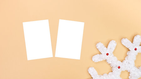 A festive mockup featuring a decorative snowflake and two blank white cards, ideal for creating holiday greetings or promotional materials. Perfect for winter-themed designs.の写真素材