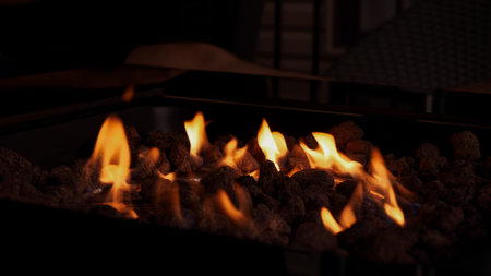 A modern fire pit sits elegantly in an outdoor setting, surrounded by comfortable seating. The...
