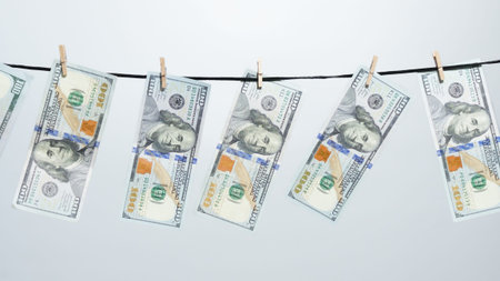 Concept of money laundering, financial crime, and illegal income. Several hundred dollar bills...