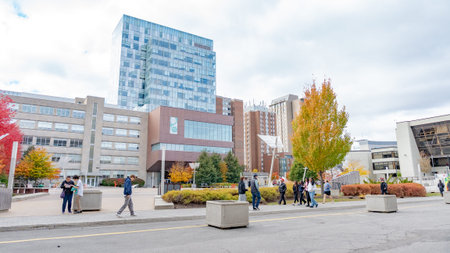 Ottawa ON, Canada - October 25, 2025: Scene at uOttawa University with students walking through campus surrounded by colorful autumn trees and contemporary buildingsのeditorial素材