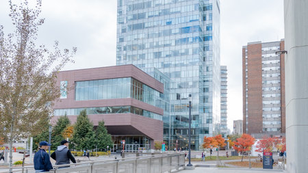 Ottawa ON, Canada - October 25, 2025: View of uOttawa University campus with modern glass architecture, surrounded by colorful autumn trees and students walking through the vibrant academic settingのeditorial素材