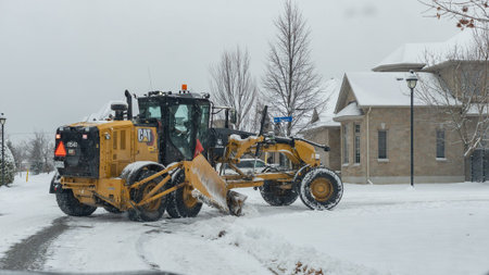 Gatineau QC, Canada - November 30, 2025: Snow plow is clearing snow from street in winter,...
