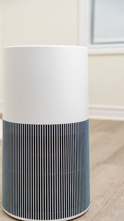 Contemporary air purifier featuring a stylish design with vertical stripes, situated in a well-lit room, improving air quality and creating a healthy environmentの写真素材