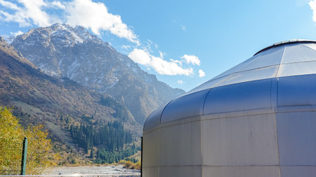 Bishkek, Kyrgyzstan - September 29, 2024: Ala-Archa Nature Park presents a modern yurt against majestic mountains, highlighting the serene beauty of Tian Shan landscapeのeditorial素材