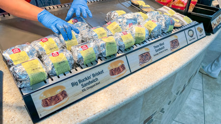 Florence SC, USA - February 28, 2026: Wrapped sandwiches are arranged on a counter at Buc-ee's,...