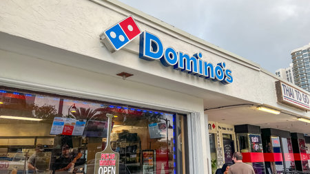 Orlando FL, USA - March 05, 2026: Domino's Pizza shop exterior showcases the iconic blue and red...