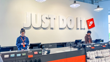 West Palm Beach FL, USA - March 05, 2026: Nike store interior showcases two employees working at...