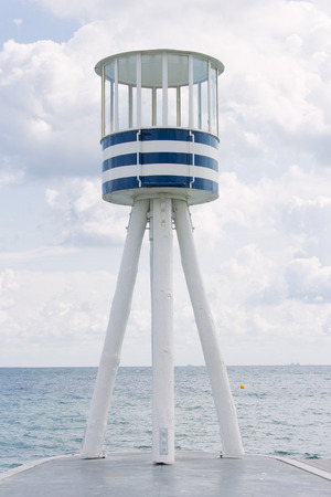 Beautiful scenery of Klampenborgs (Denmark) lighthouse at the beach on a sunny day with some clouds on the seaside.の写真素材