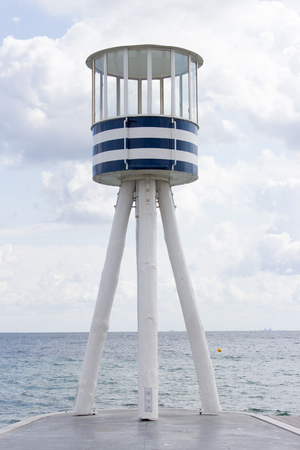 Beautiful scenery of Klampenborgs (Denmark) lighthouse at the beach on a sunny day with some clouds on the seaside.の写真素材