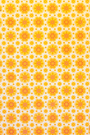 An empty room with yellow and orange vintage wallpaper and wooden floor.の写真素材