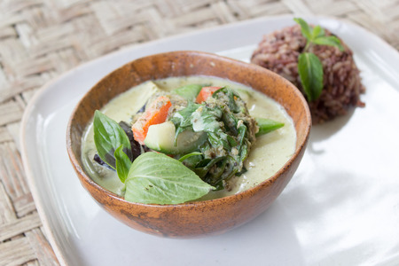 Homemade Green Thai Curry served with brown rice in a bowl and a plate. Originally made in Thailand.の写真素材