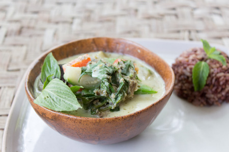 Homemade Green Thai Curry served with brown rice in a bowl and a plate. Originally made in Thailand.の写真素材
