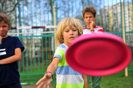 Kids with a flying disk outdoorsの写真素材