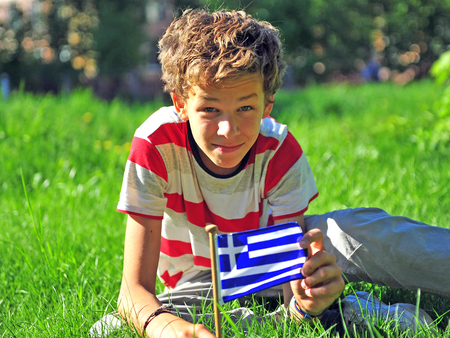 Teenager in the park with national flag of Greeceの写真素材