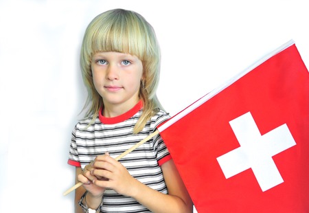 Adorable boy with a national flag of Switzerland on white backgroundの写真素材