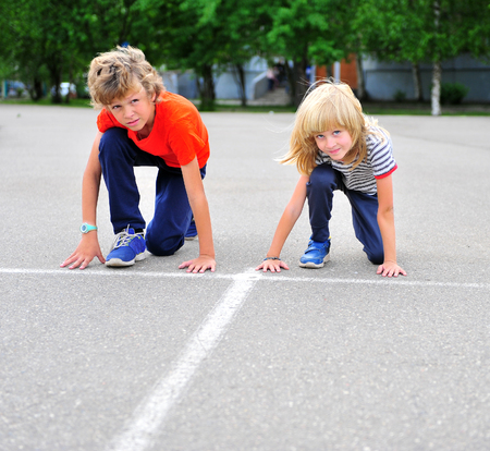 Two active children before the start, summer running competition outdoorsの写真素材