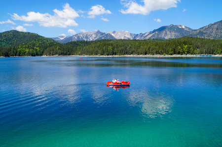 Aerial view of a boat on a lake with mountains in the background