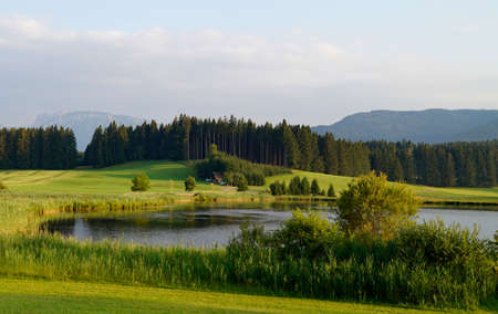 Hiking trail overlooking scenic Attlesee in the Bavarian Alps, Nesselwang, Allgaeu or Allgau, Germanyの写真素材