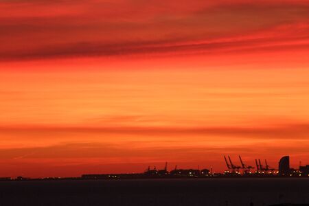 Skyline port crane Barcelona sunset silhouetteの写真素材