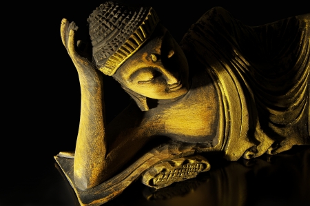 Teak wood lying buddha on blackの写真素材