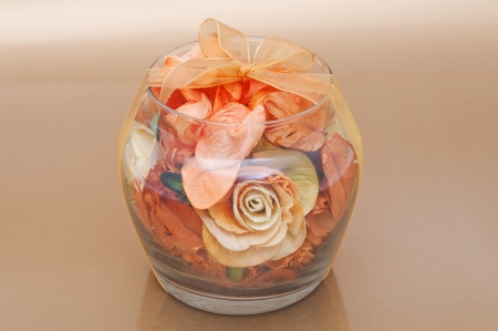 Dried flowers inside transparent glass bowl on beige background.の写真素材