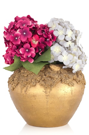 Pottery vase with artificial flowers isolated on whiteの写真素材