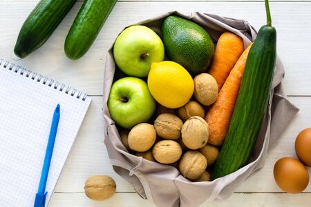 Grocery bag with healthy clean eating on a light backgroundの写真素材