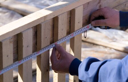 Male hands holding centimeter and measure distance.の写真素材