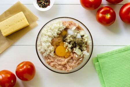 Step by step recipe of stuffed tomatoes. Minced chicken with rice, egg and onions in a bowl.の写真素材