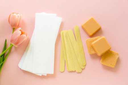 Depilatory items with wax for remove hair on a colored background.
