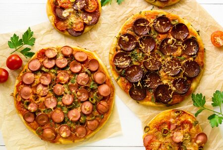 Pizza with sausage, olives and cheese on a light background.の写真素材