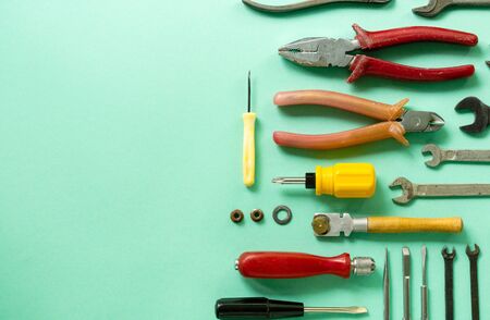 Flat lay of repair tools on a mint background.の写真素材