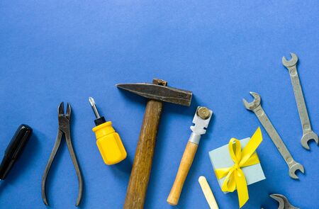 Flat lay for father's day with tools and gift box on a blue background.の写真素材
