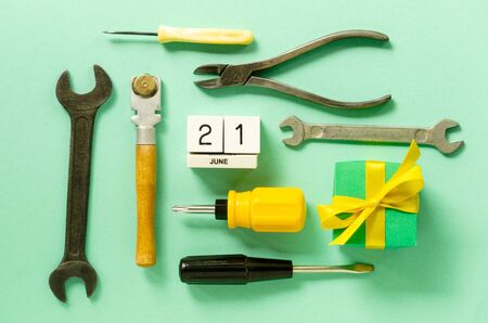 Flat lay for father's day with tools and gift box on a mint background.の写真素材