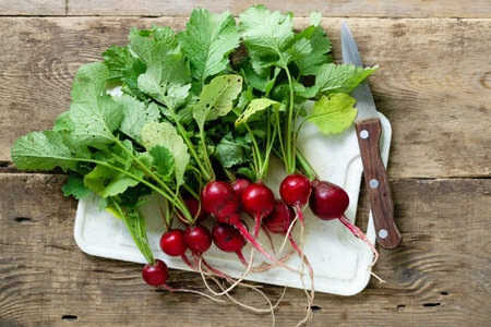 Bunch of garden radish on old wooden background.