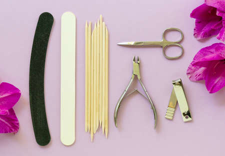 Flat lay of tools for manicure and pedicure on a lilac backgroundの写真素材